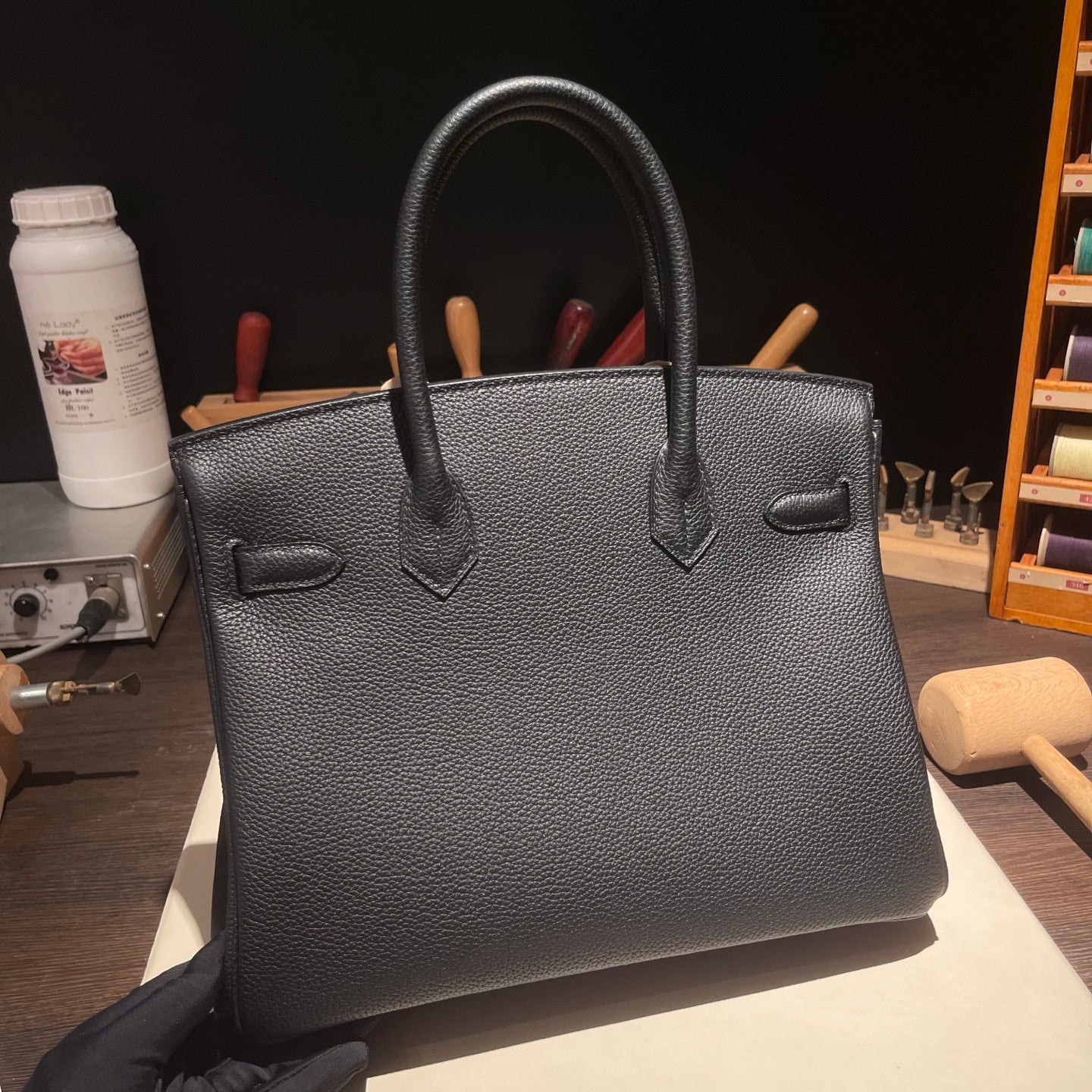 Hand-stitched black Togo leather handbag detail