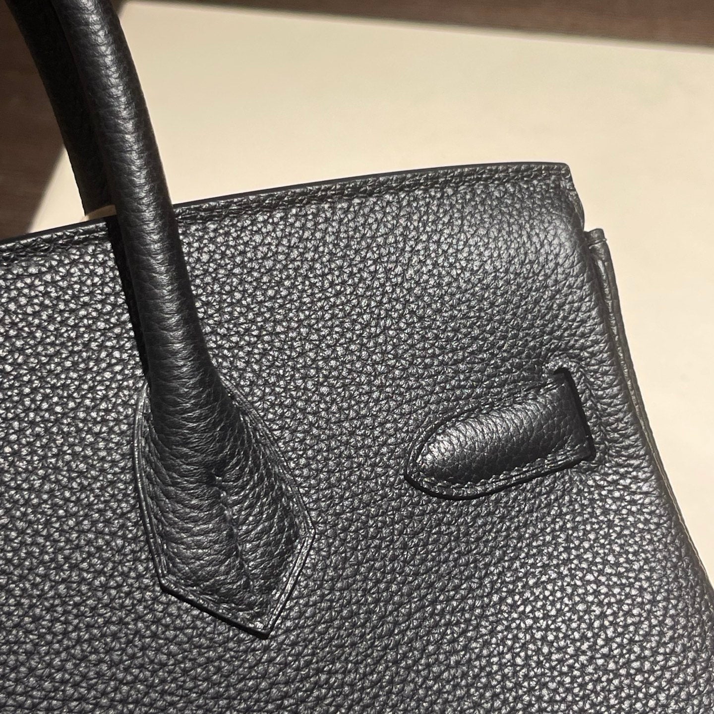 Black handcrafted top handle bag leather detail